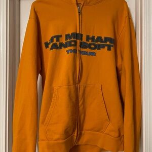 Hit Me Hard And Soft tour orange zip up hoodie.